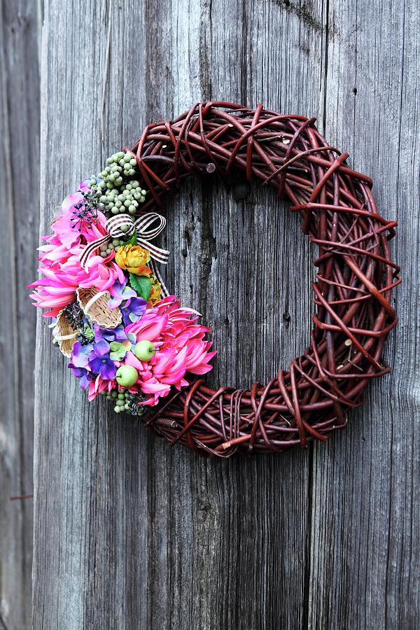 Wicker Wreath With Multicoloured Flowers On Wooden Wall Photograph by ...