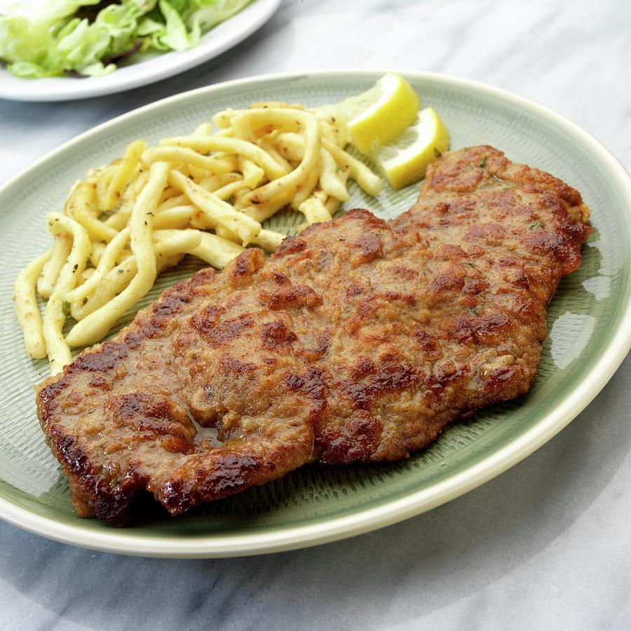 Wiener Schnitzel breaded Veal Escalope From Vienna With Sptzle soft Egg Noodles From Swabia Photograph by Paul Poplis