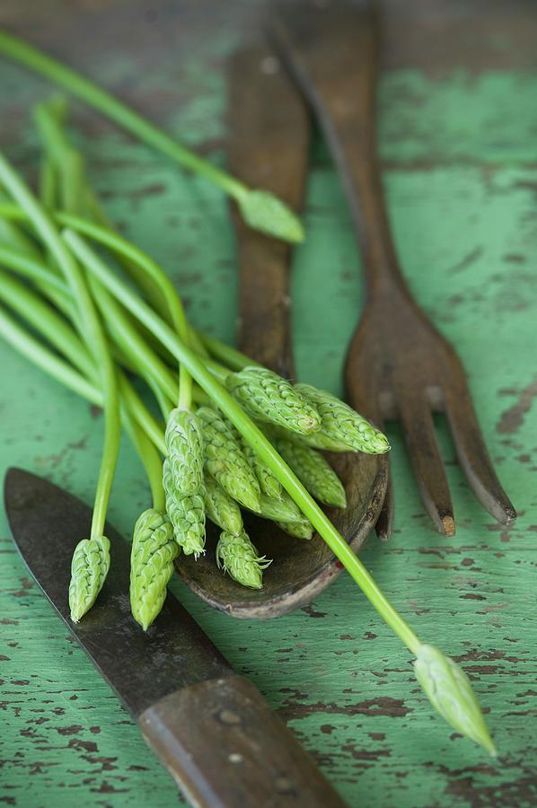 Wild Asparagus On A Rustic Wooden Table With Salad Servers And A Knife Photograph by Achim Sass