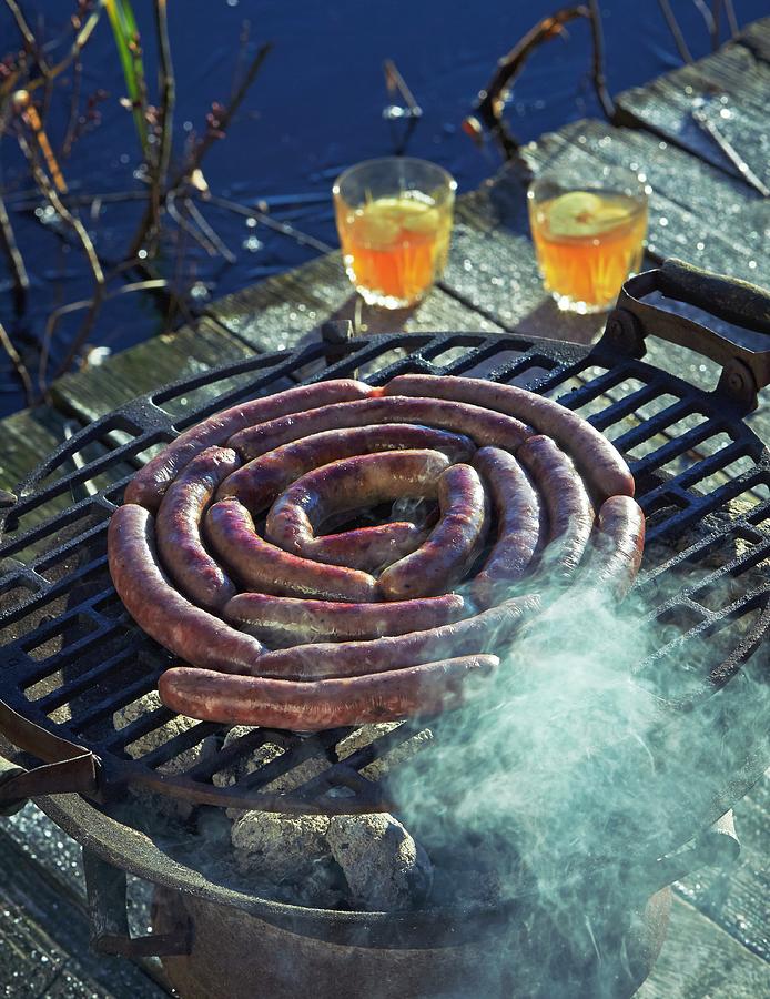 Wild Boar Sausages On A Hot Barbecue Photograph by Hannah Kompanik
