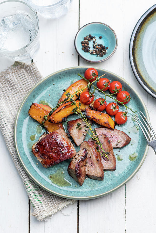 Wild Boar Steak With Grilled Hokkaido Pumpkin, Cherry Tomatoes And Thyme Photograph by Angelika Grossmann