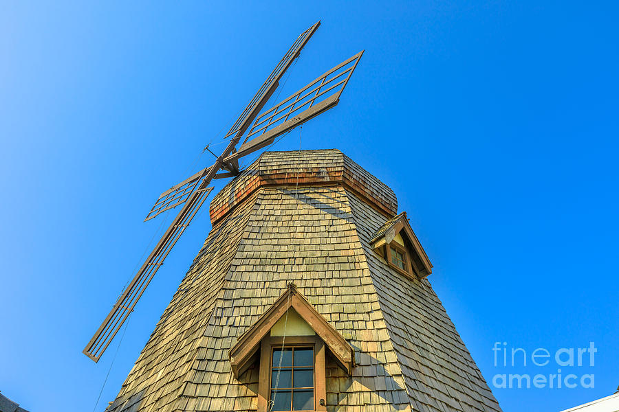 Windmill in blue sky Photograph by Benny Marty