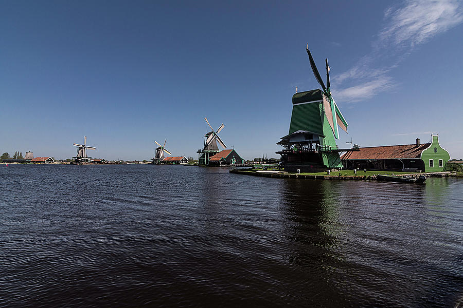Windmills at the lake Photograph by Wolfgang Stocker