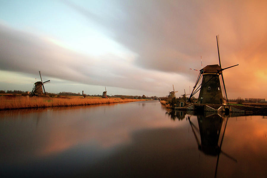 Windmills At Waterfront In Kinderdijk Photograph by Kees Smans