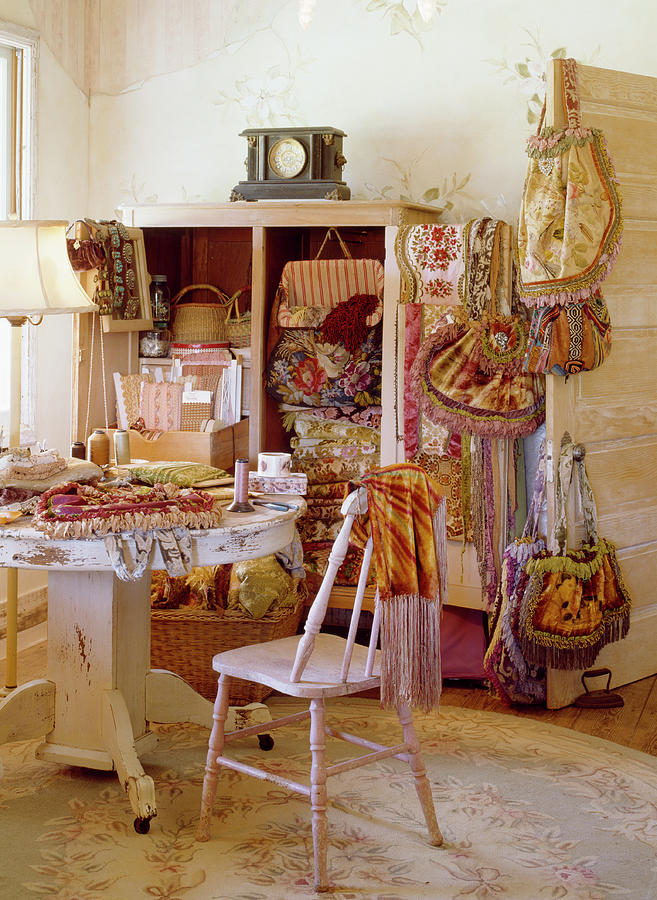 Windsor Chair And Pedestal Table In Front Of Textiles And Bags In And Around Cupboard Photograph by Brian Harrison