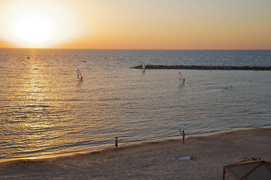 Windsurfers On Water At Sunset Photograph by Barry Winiker