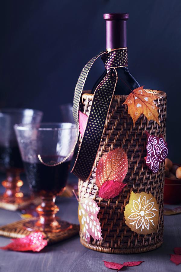 Wine Bottle Holder Decorated With Colourful, Painted Autumn Leaves Photograph by Franziska Taube