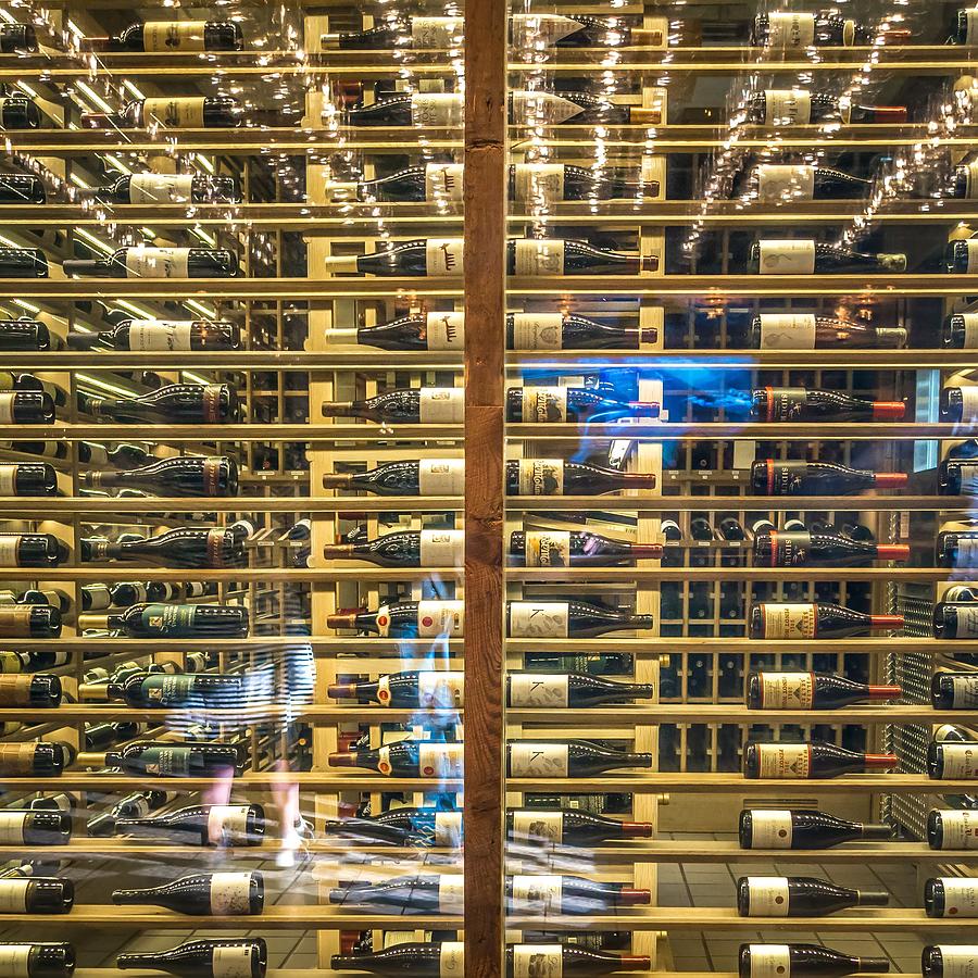 Wine Bottles On Wine Racks In A Restaurant Photograph by Alex Grichenko