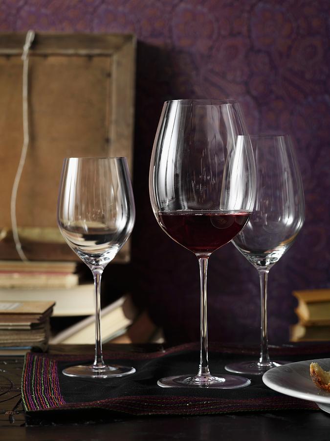 Wine Glasses And Books In Front Of A Purple Background Photograph by Biglife