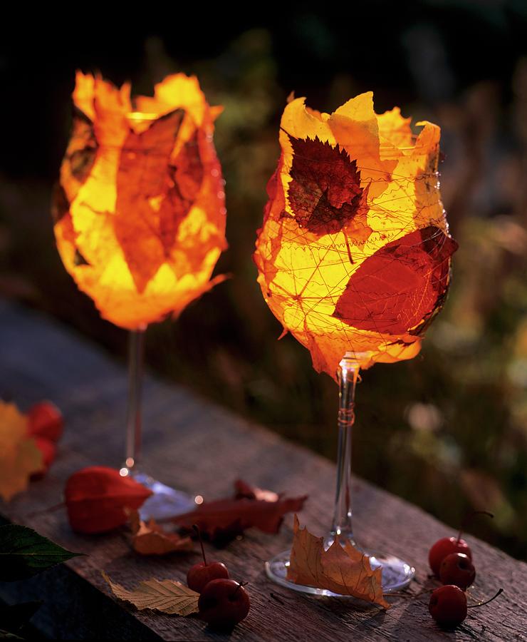 Wine Glasses With Tea Lights, With Colourful Autumn Leaves Photograph by Friedrich Strauss