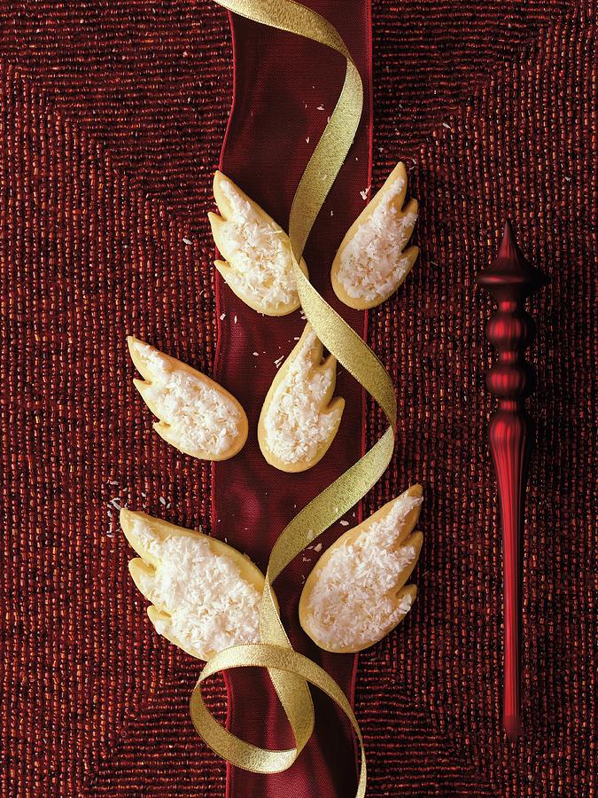 Wing-shaped Biscuits Decorated With Icing Sugar And Grated Coconut Photograph by Jalag / Wolfgang Schardt