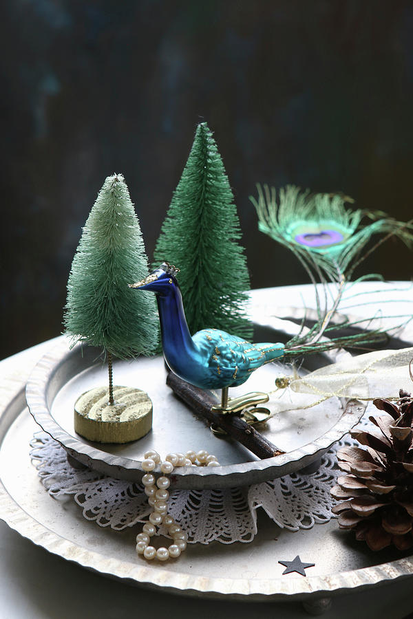 Winter Arrangement Of Peacock Figurine And Miniature Trees On Metal Plates Photograph by Regina Hippel