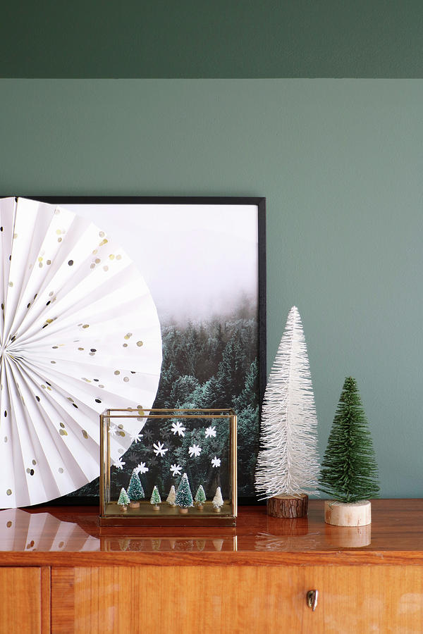 Wintry Arrangement Of Miniature Trees In Front Of Picture Of Forest Photograph by Marij Hessel