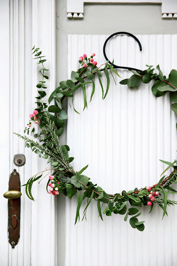 Wintry Wreath Of Eucalyptus And Snowberries On Door Photograph by Birgitta Wolfgang Bjornvad