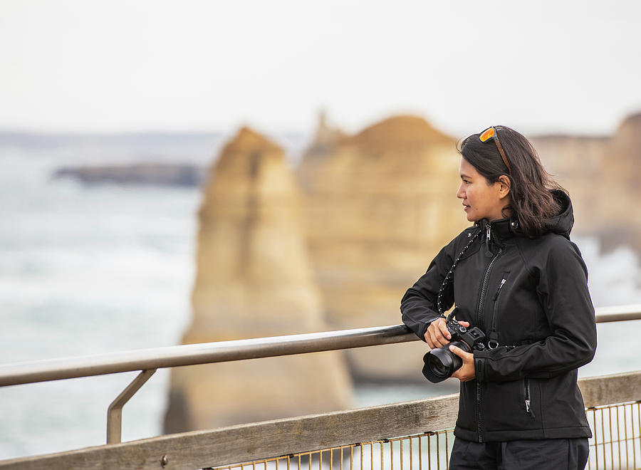 Winter Photograph - Woman Admiring The 12 Apostles Sea Stacks In The South Of Australia by Cavan Images