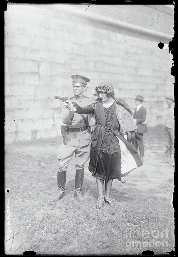 Woman Aiming A Gun Photograph by Bettmann