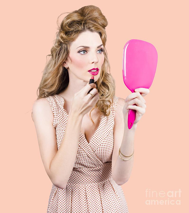 Woman applying lip makeup with cosmetics mirror Photograph by Jorgo Photography