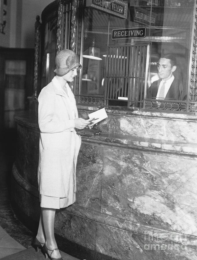 Woman At Tellers Cage In Bank Photograph by Bettmann