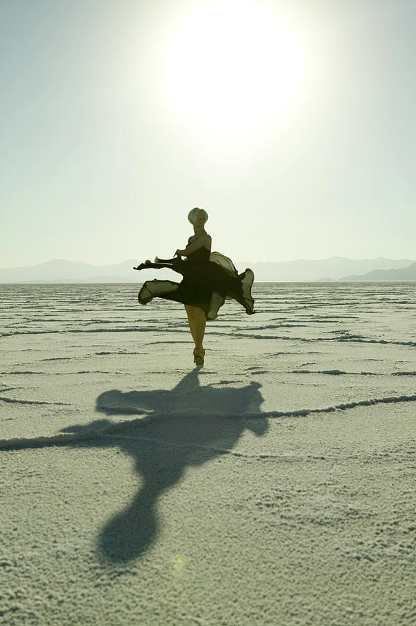 Woman Dancing In Desert At Sunrise Photograph by Photodisc