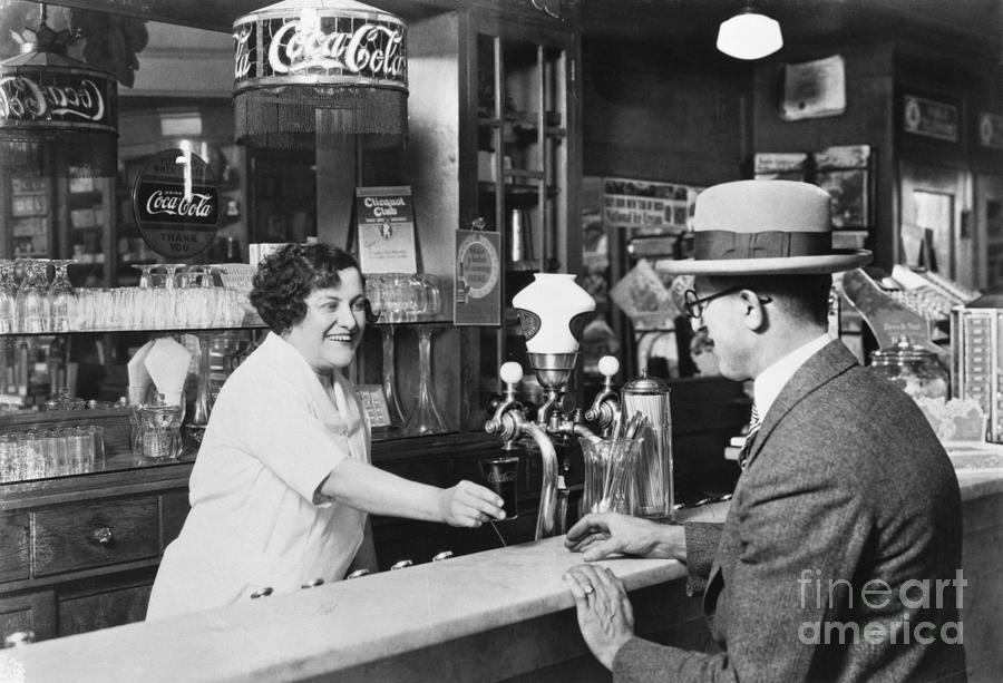 Hat Photograph - Woman Dispensing Coke At Soda Fountain by Bettmann