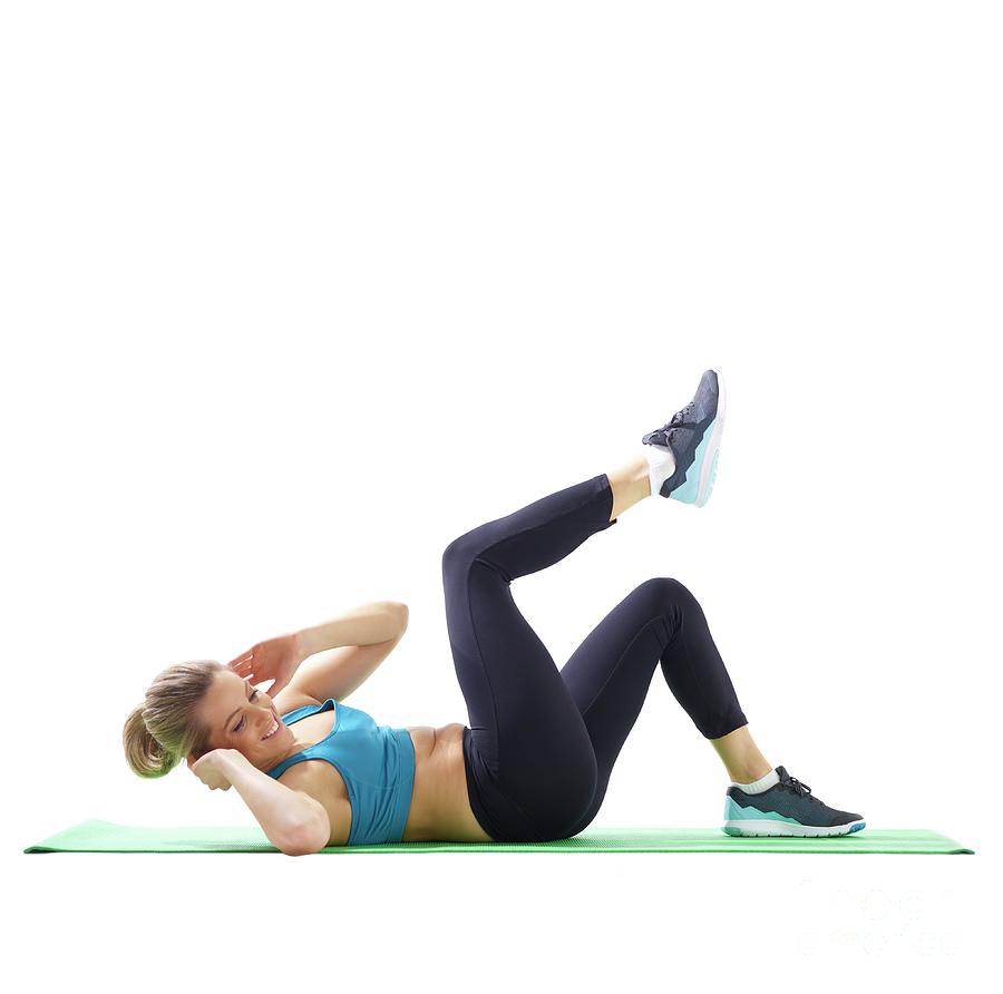 Woman Doing Lateral Crunch Photograph by Science Photo Library