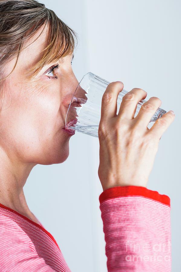 Woman Drinking Glass Of Water Photograph by Cristina Pedrazzini/science Photo Library