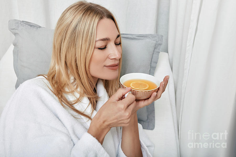 Woman Drinking Tea At A Spa Photograph by Peakstock / Science Photo Library