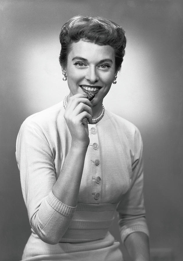 Woman Eating Chocolate In Studio, B&w Photograph by George Marks