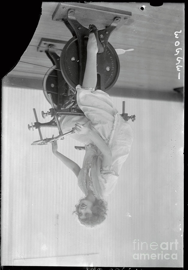 Woman Exercising On Stationary Bike Photograph by Bettmann
