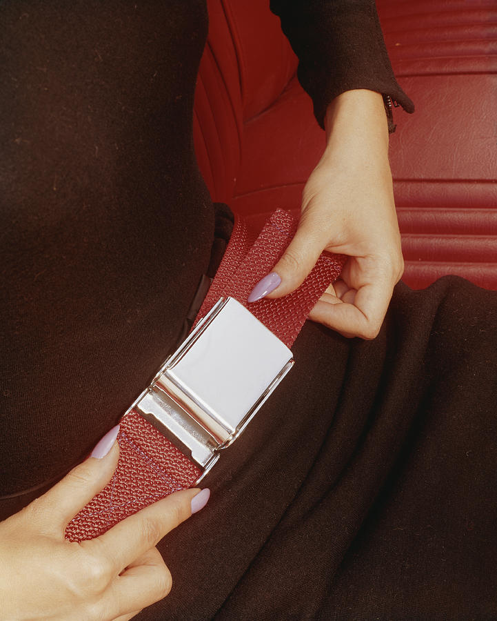 Woman Fastening His Seatbelt, Close-up Photograph by Tom Kelley Archive