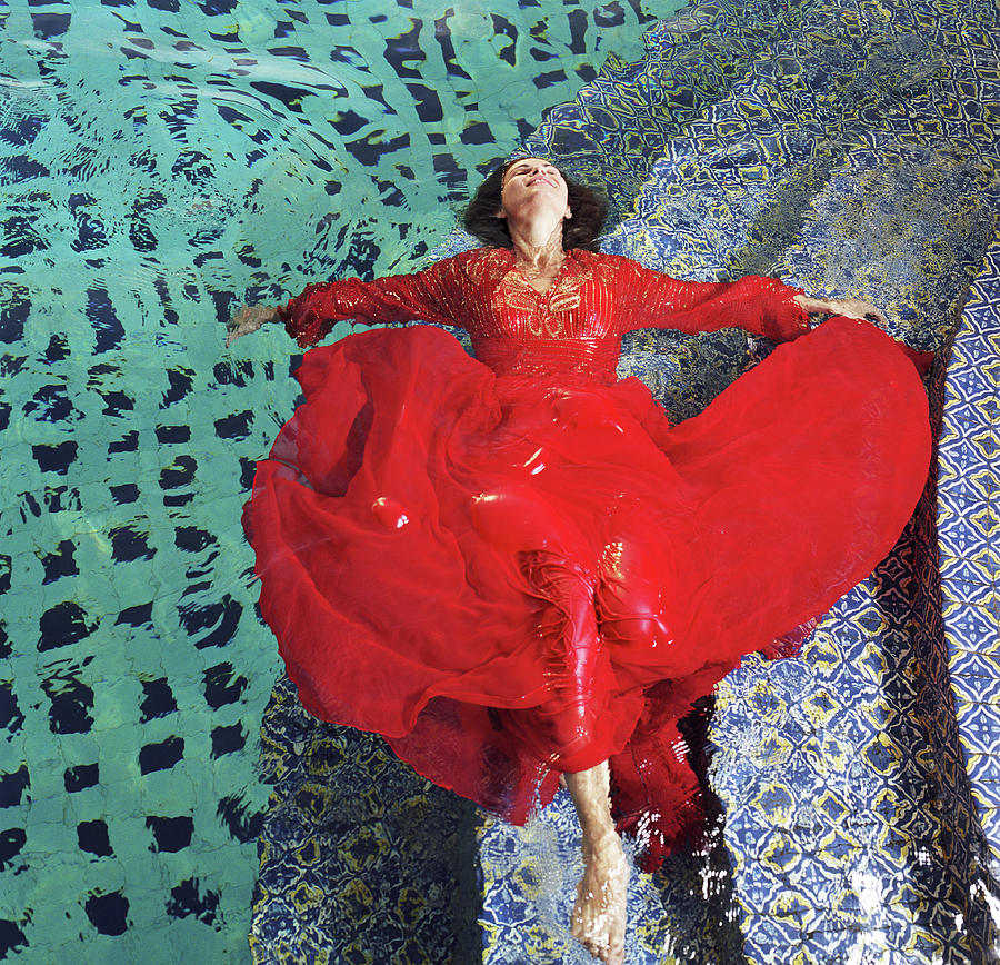 Woman Floating In Pool, Wearing Red Photograph by Tony Anderson