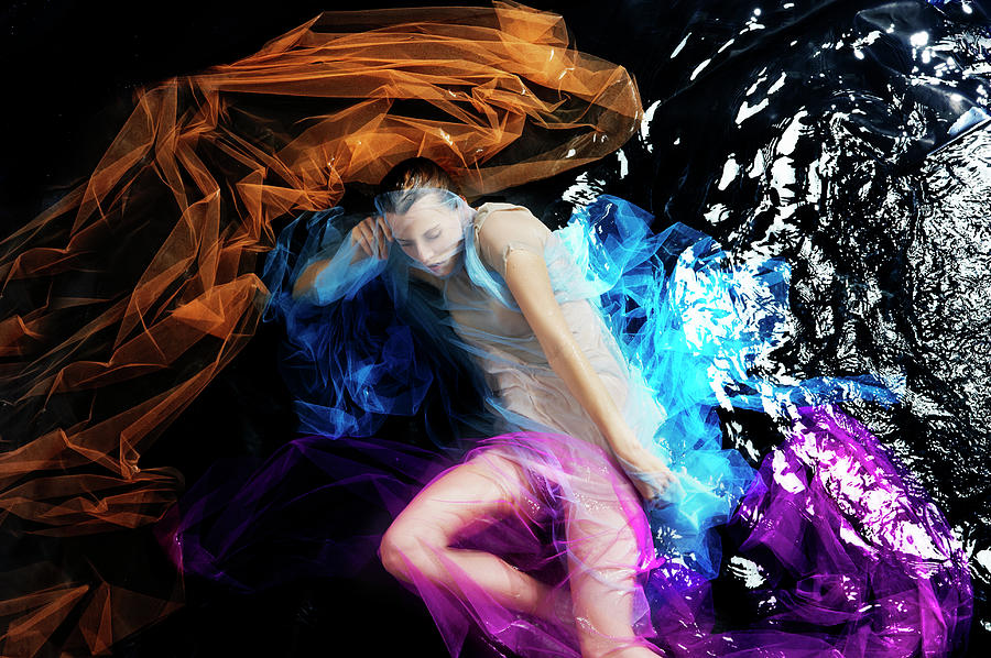 Woman Floating In Water With Colored Photograph by Tara Moore
