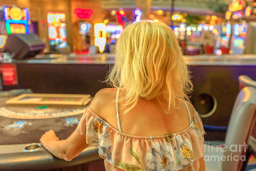 Woman gambling at blackjack table Photograph by Benny Marty