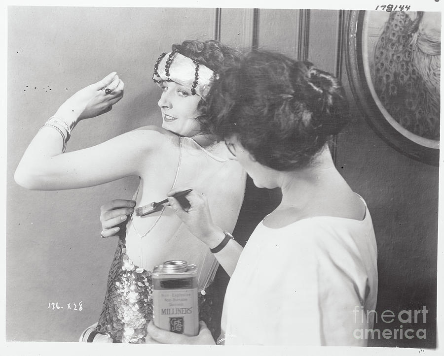 Woman Gluing On Strapless Dress Photograph by Bettmann