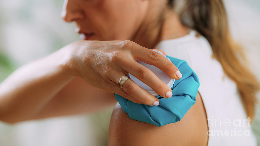 Woman Holding Cold Press Onto Arm Photograph by Microgen Images/science Photo Library