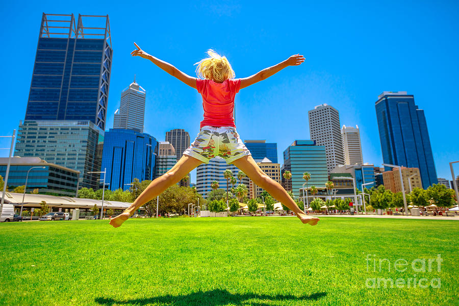 Woman jumping in Perth downtown Photograph by Benny Marty