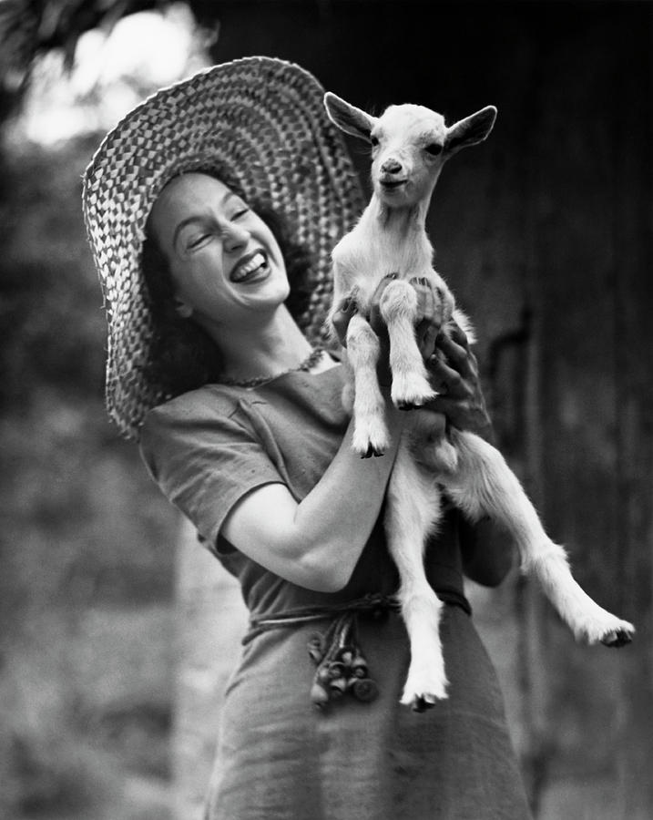 Woman Laughing And Holding A Goat Photograph by George Marks