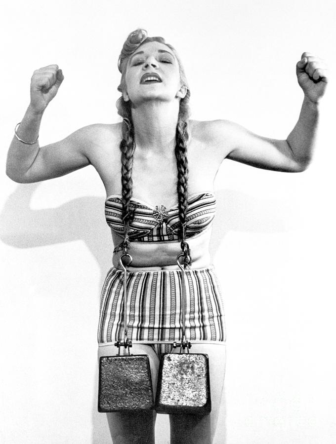 Woman Lifting Weights With Pigtails Photograph by Bettmann
