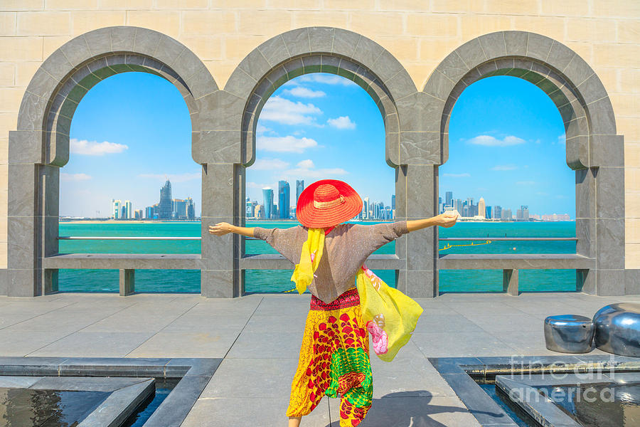 Woman looking Doha skyline Photograph by Benny Marty