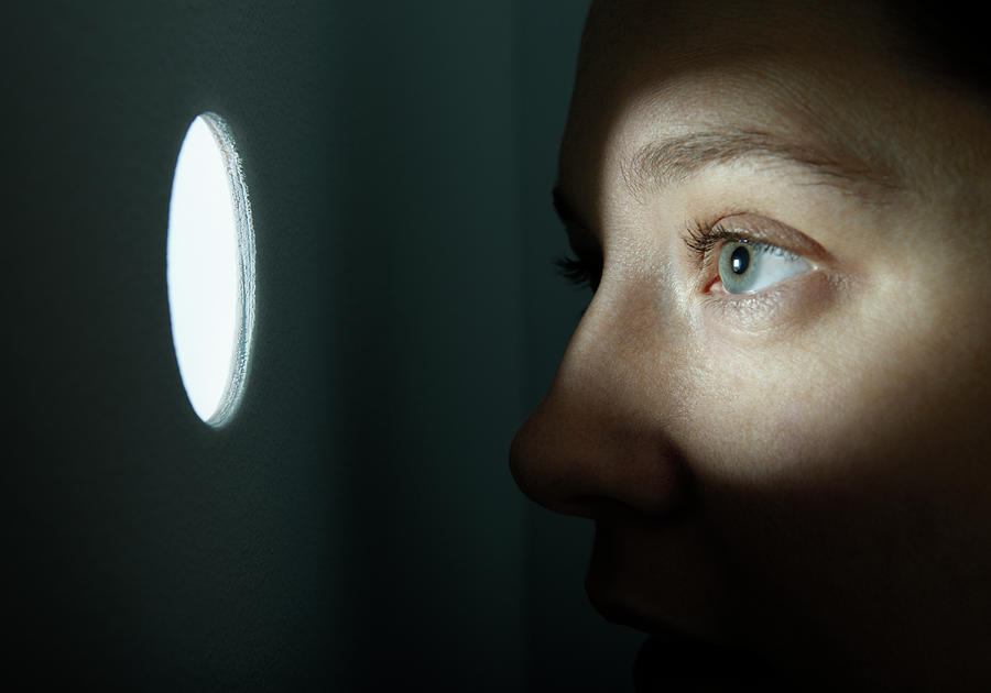 Woman Looking Through Illuminated Peep Photograph by Andy Ryan