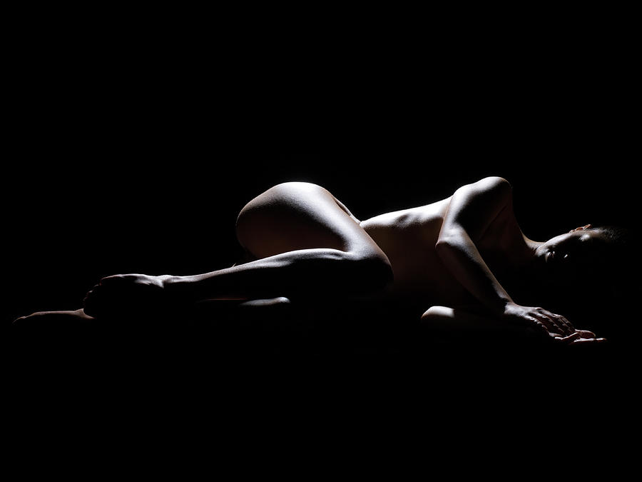 Woman Lying Down In The Dark Photograph by Michael H