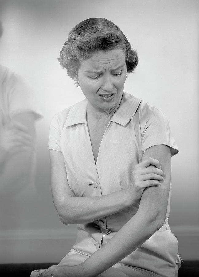 Woman Massaging Arm Photograph by George Marks