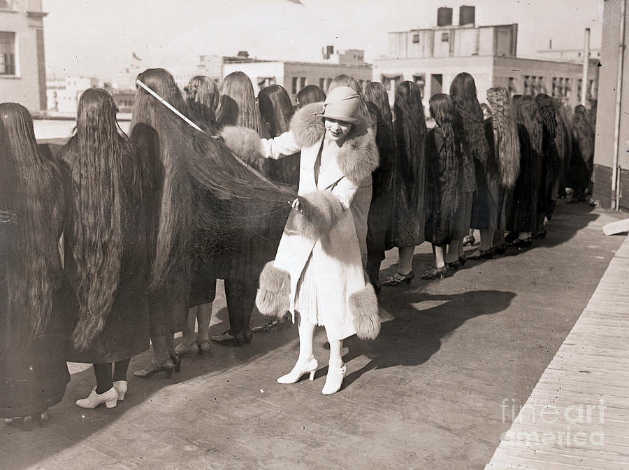Woman Measuring Long Hair In Contest Photograph by Bettmann