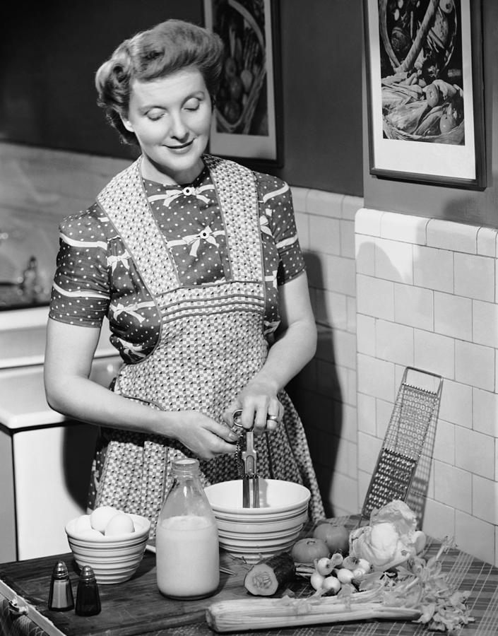 Woman Mixing Ingredients In Bowl Photograph by George Marks