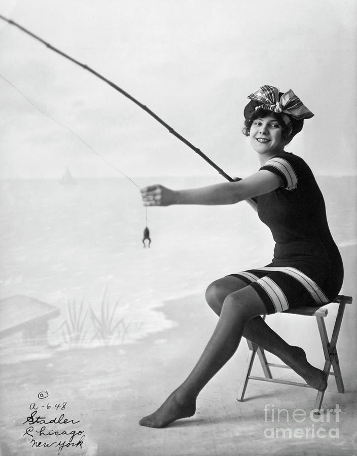Woman On Beach With Frog On Fishing Pole by Bettmann