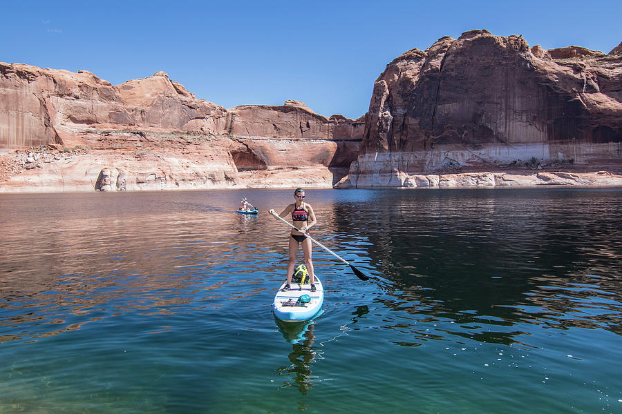 Desert Photograph - Woman Paddleboarding On Lake, Utah, Usa by Suzanne Stroeer