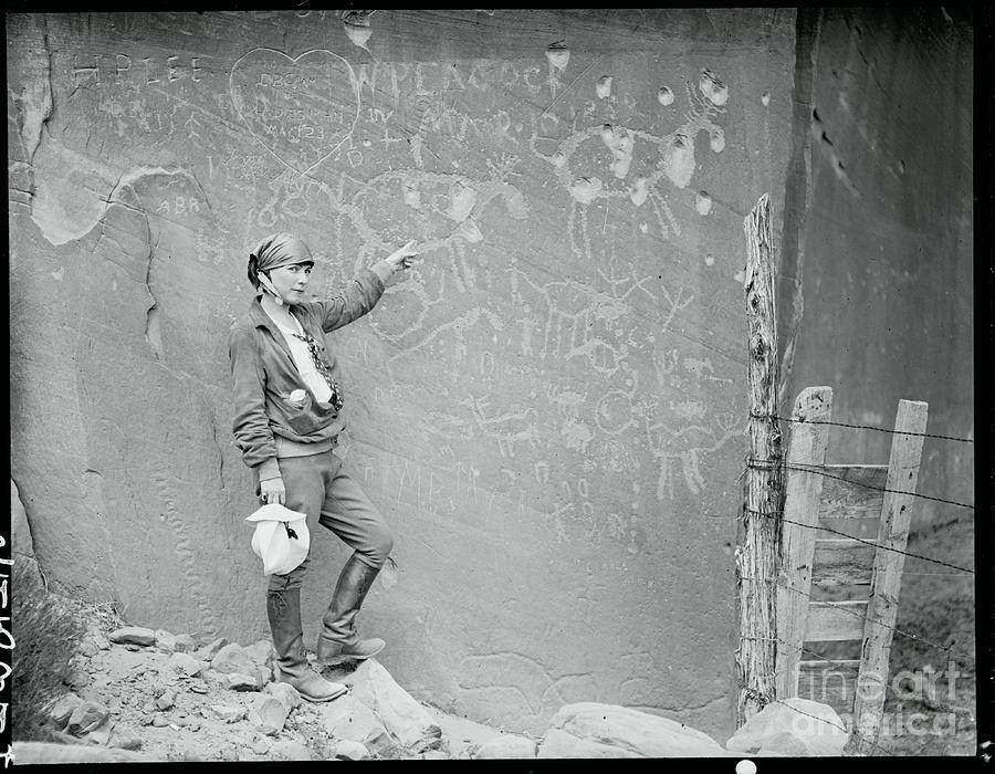 Woman Pointing To Pictographs Photograph by Bettmann