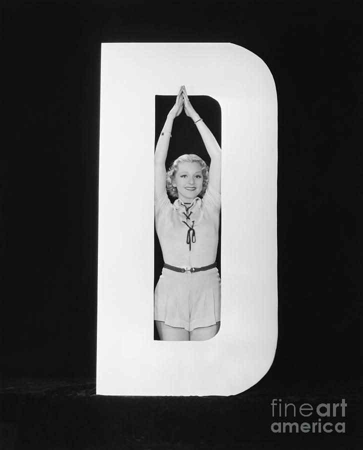 Behind Photograph - Woman Posing In Middle Of Letter D by Everett Collection Behind Photograph - Woman Posing In Middle Of Letter D by Everett Collection