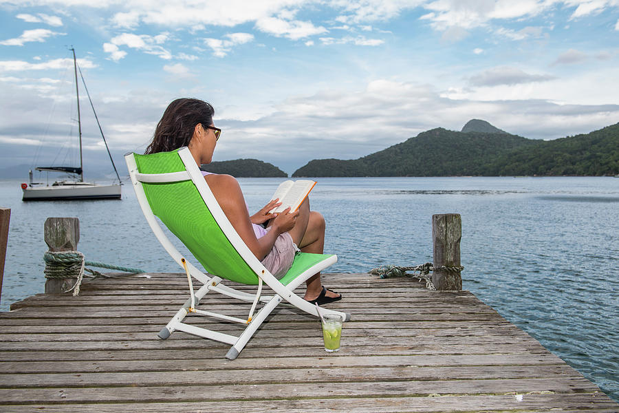 Summer Photograph - Woman Relaxing On Pier On The Tropical Island Of Ilha Grande by Cavan Images