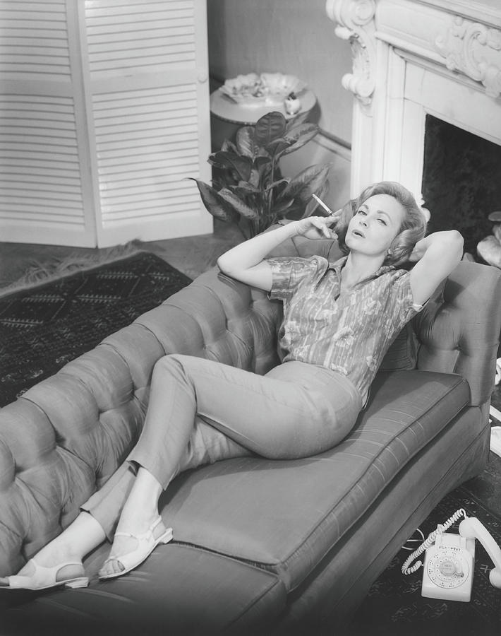 Woman Relaxing On Sofa, B&w, Elevated Photograph by George Marks
